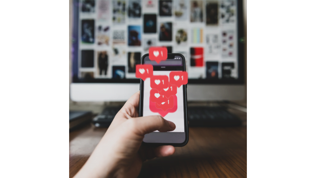 A person holding a smartphone with a red heart on it, representing a heart reaction phone.