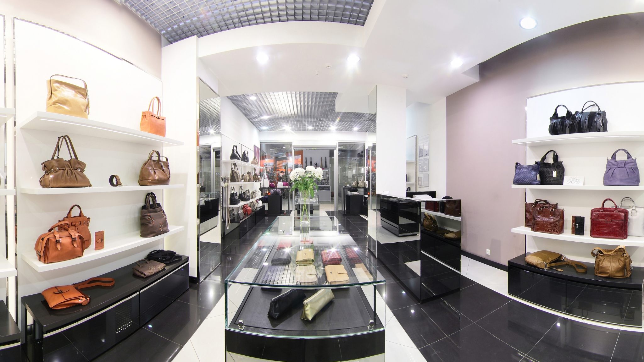 A variety of purses on display in a bags showroom.