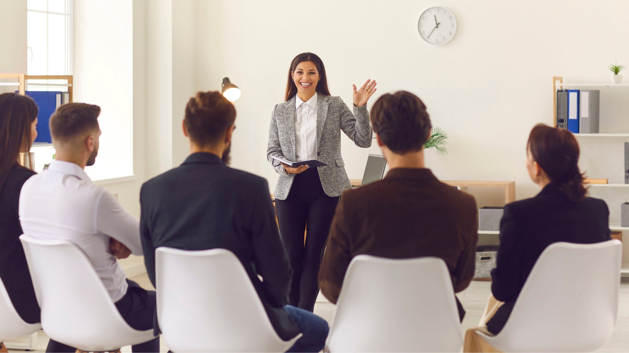 A woman presenting to a group seminar