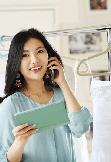 A person holding a product and smiling while talking to a customer