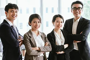 Smiling colleagues posing together for a photo, radiating happiness and camaraderie