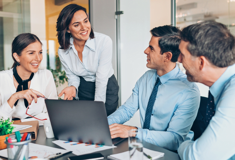 Business professionals collaborating in an office, engaged in a team conversation to enhance productivity.